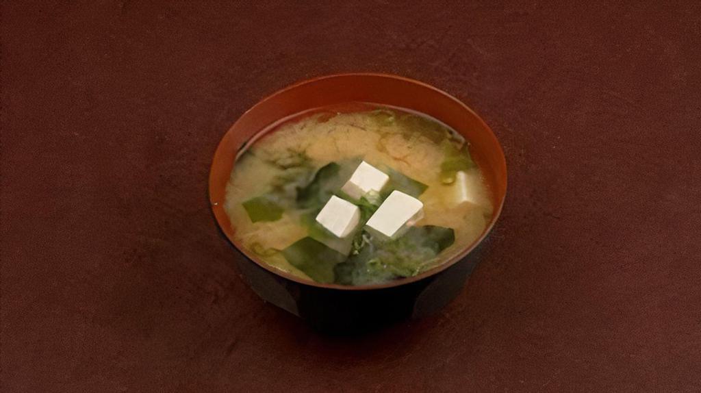 Miso Shiru · The traditional miso soup with tofu cubes, wakame seaweed, and green onions.