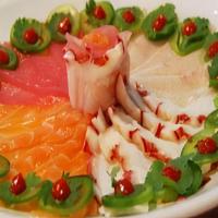 Razor Sashimi Sampler · Assortment of thinly sliced sashimi including tuna, salmon, yellowtail and octopus topped wi...