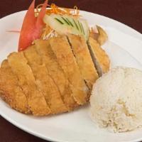 Katsu · Panko-breaded pork tenderloin served with rice, sliced cabbage, carrots, tomato and cucumber.
