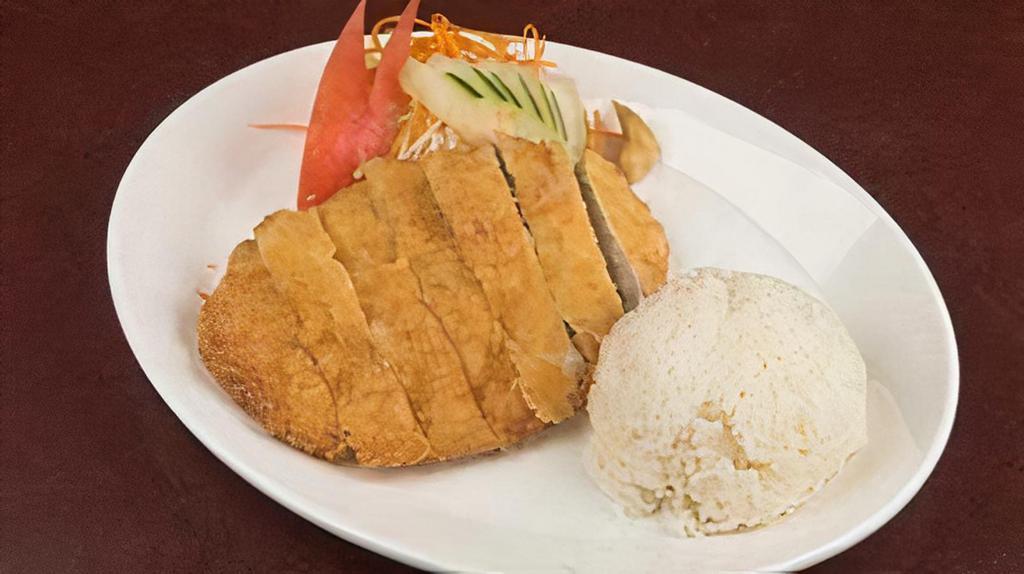 Katsu · Panko-breaded pork tenderloin served with rice, sliced cabbage, carrots, tomato and cucumber.