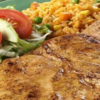 Pechuga De Pollo Marinada · Marinated chicken breast served with rice, refried beans, avocado, lettuce, tomatoes and tor...
