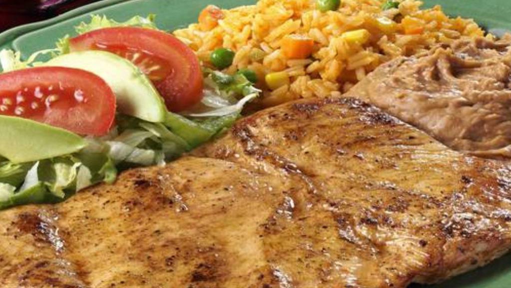 Pechuga De Pollo Marinada · Marinated chicken breast served with rice, refried beans, avocado, lettuce, tomatoes and tortillas.