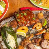 Parrilla Mixta · The pride of mama Ninfas. A combination plate for two loaded with beef and chicken fajitas, ...
