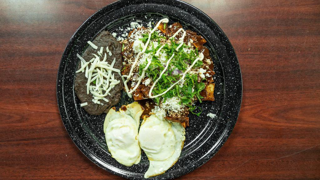 Chilaquiles Rojo, Verde & Mole · Two scrambled eggs, potatoes, onion and cilantro, side of black beans.