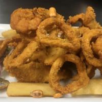 Chicharron De Calamares · Fresh calamari deep fried seasoned with salt, pepper and garlic. This plate is served with y...