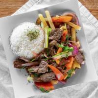Lomo Saltado · Militer tenders of marinated beef seasoned with green onions, tomatoes, onions, and soy sauc...