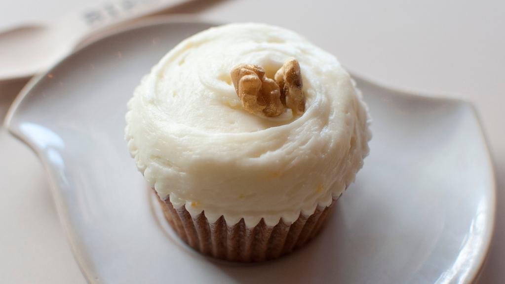 Award Winning Carrot Cake  · Carrot cake topped with a citrus cream cheese frosting and garnished with a gilded walnut. Contains nuts.