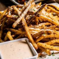 Garlic Pommes Frites · Fresh-cut shoestring fries, sprinkled with garlic and parmesan. Garnished with  parsley,  se...
