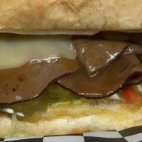 Roast Beef And Gravy Poboy · Cajun Roast Beef cooked in Cajun brown Gravy on French Bread dressed with Mayo, lettuce, Tom...