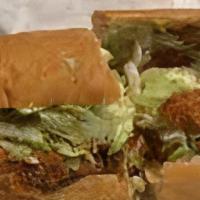 Catfish Poboy · Fried Louisiana Catfish on French Bread dressed with Mayo, lettuce, Tomatoes and Pickles wit...