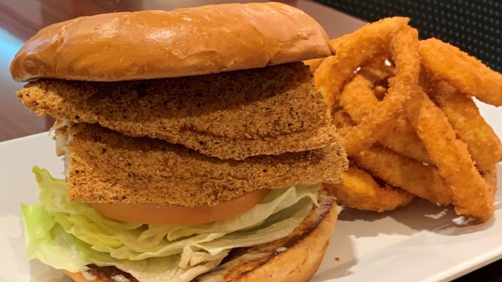 Catfish Sandwich · Fried catfish filet, lettuce, tomato, onion, pickle, mayo & old bay seasoning.  Served with seasoned fries  or Add $1 to sub onion rings.