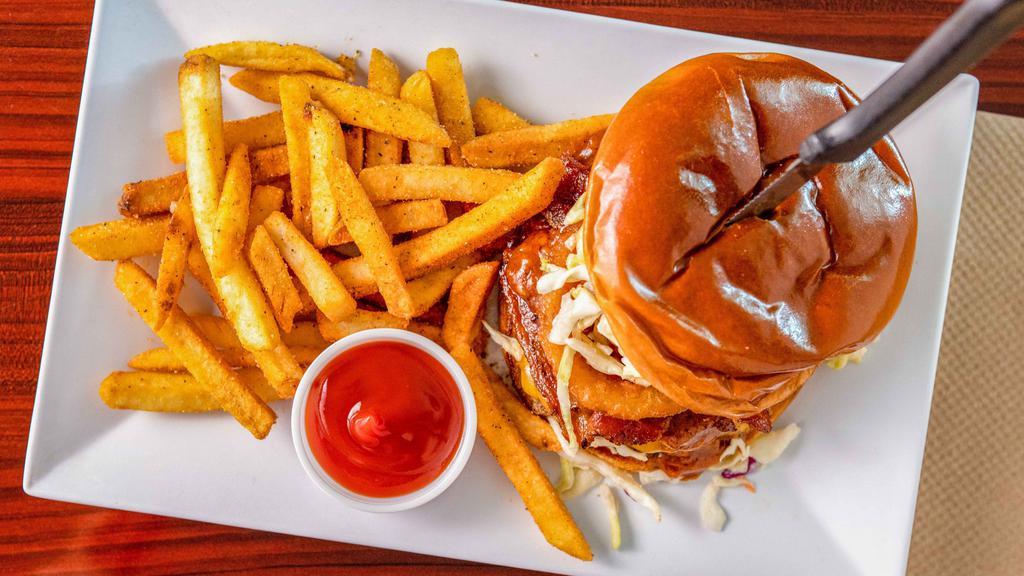 Western Burger · 8 ounces beef patty, bacon, cheddar cheese, fried onion rings, BBQ chipotle sauce and Mayo. Served with Seasoned Fries or add $1 to sub onion rings