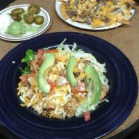 Fajita Salad · Diced beef or chicken fajita served over a bed of lettuce, topped with tomatoes, sliced avoc...