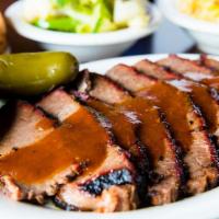 Brisket Dinner · Smoked Brisket Topped With Our Homemade BBQ Sauce and Two Side Orders of Your Choice.