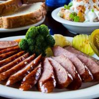 Link Sausage Dinner · Sliced Smoked Sausage Links Topped With Our Homemade BBQ Sauce and Two Side Orders of Your C...