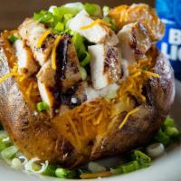 Grilled Chicken Baked Potato · Fresh Baked Potato Loaded With Butter, Cheese, Sour Cream, Bacon Bits and Green Onions. Topp...
