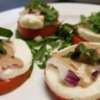 Caprese Salad · Sliced tomato, red onion, fresh mozzarella, basil and balsamic vinegar.