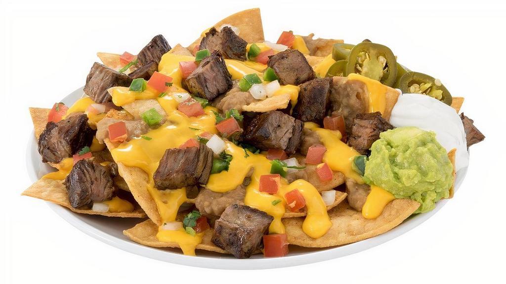 Loaded Nachos · Nachos made with our fresh Regio seasoned chips and your choice of the following meat: Chorizo, Barbacoa, Pastor, Chicken, and Grilled Beef. Topped with Queso, Refried Beans, Sliced Jalapeños, Pico de Gallo, Sour Cream, and Guacamole.