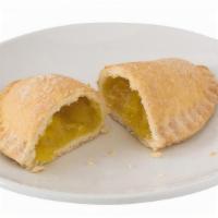 Pineapple Empanada · A Baked Pastry filled with Pineapple. Covered in a mixture of Cinnamon and Sugar.