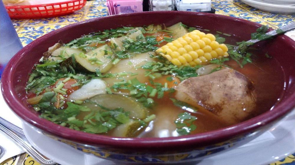 Caldo Tlalpeño (Chicken Soup) · Made with chicken, zucchini, potatoes, corn, and carrots, Monterey cheese, chipotle sauce, and diced avocado served on the side. Served with your choice of fresh homemade flour or corn tortillas.