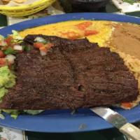 Tampiqueña · Beef skirt steak with (1) cheese enchilada, served with rice, beans, pico De gallo, guacamol...