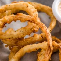 Onion Rings · Buttermilk hand breaded fresh onions served with texas petal sauce. * 
 
*Not served at our ...