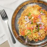 Bhel Puri · Crispy puffed rice and chickpea noodle tossed with onion, tomatoes, sweet and spicy sauces w...