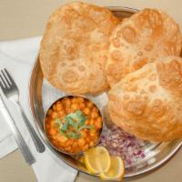 Chole Bhatura · Garbanzo curry with fried puffed wheat bread.