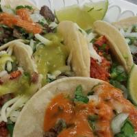 Taco Plate · 4 tacos lengua or tripa, served with rice & beans.