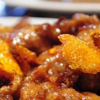 Orange Beef · Spicy. Tender sliced of beef sautéed with orange peels and hot pepper in a sweet hot sauce.