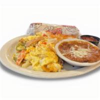 Migas · Scrambled eggs with tortilla chips, jalapeño peppers, tomato and onions, Jack and Cheddar ch...