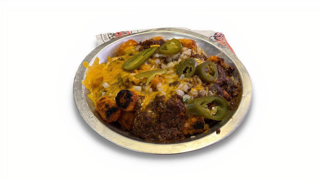 Chili Cheese Tots Or Fries · Tater tots or fries smothered in Texas Cafe chili topped with diced onions, jalapeños and melted Cheddar cheese.