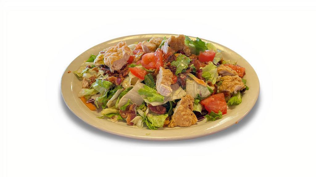 Crispy Chicken Chopped Club Salad · Crispy chicken, bacon, boiled eggs, tomatoes and homemade croutons. Chopped and tossed in our signature honey dijon dressing.