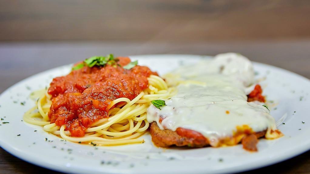 Eggplant Parmigiana · Lightly breaded eggplant, topped with tomato sauce and Mozzarella cheese served with a side of pasta.