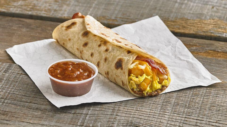 Bacon Q Taco · The Bacon Q Taco is made with signature potato & egg, refried pinto beans, shredded cheese, and a freshly grilled slice of bacon served on a fresh flour or corn tortilla.