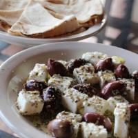 Feta & Olives · Creamy Greek sheep's milk Feta and Kalamata olives served with warm pita bread.