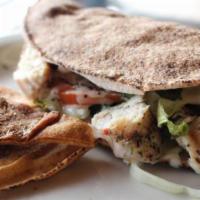 Chicken Souvlaki Pita · Chunks of grilled chicken with lettuce tomato and onion in a warm pita bread served with tza...