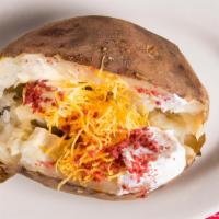 Baked Potato · Large Idaho potato loaded with butter, cheese , sour cream and bacon.