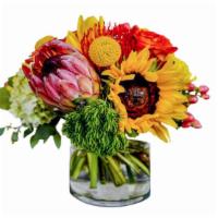 Ginger And Sunshine · A mixture of seasonal and tropical flowers that are hand-tied and placed in a clear glass va...