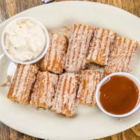 Churros · *BAJA FAVORITE* 
Fresh churros topped with cinnamon, stuffed with caramel and served with a ...