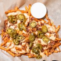 Queso Fries  · Topped with queso, bacon, jalapenos and ranch.