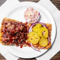 Barbeque Sandwich · House smoked brisket or pulled pork, barbecue sauce, red onions, pickles, choice of side and...