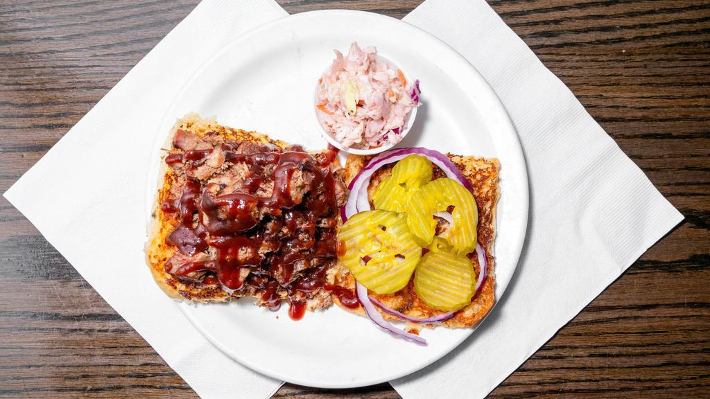 Barbeque Sandwich · House smoked brisket or pulled pork, barbecue sauce, red onions, pickles, choice of side and coleslaw.