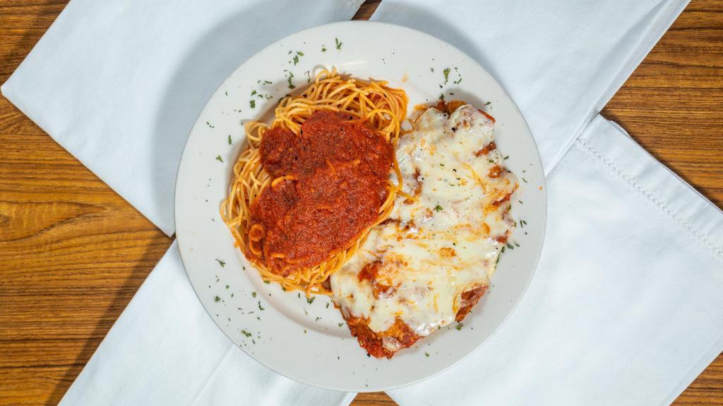 Chicken Parmigiana · Breaded chicken in marinara sauce with a  side of spaghetti.