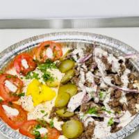 Gyro Bowl · Served over Rice, over Hummus, or both, with fresh lettuce, pickles, tomato, cucumber, red o...