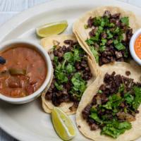 Street Tacos · Three corn tortilla tacos, with sautéed beef fajita, onion, and fresh cilantro. Served with ...