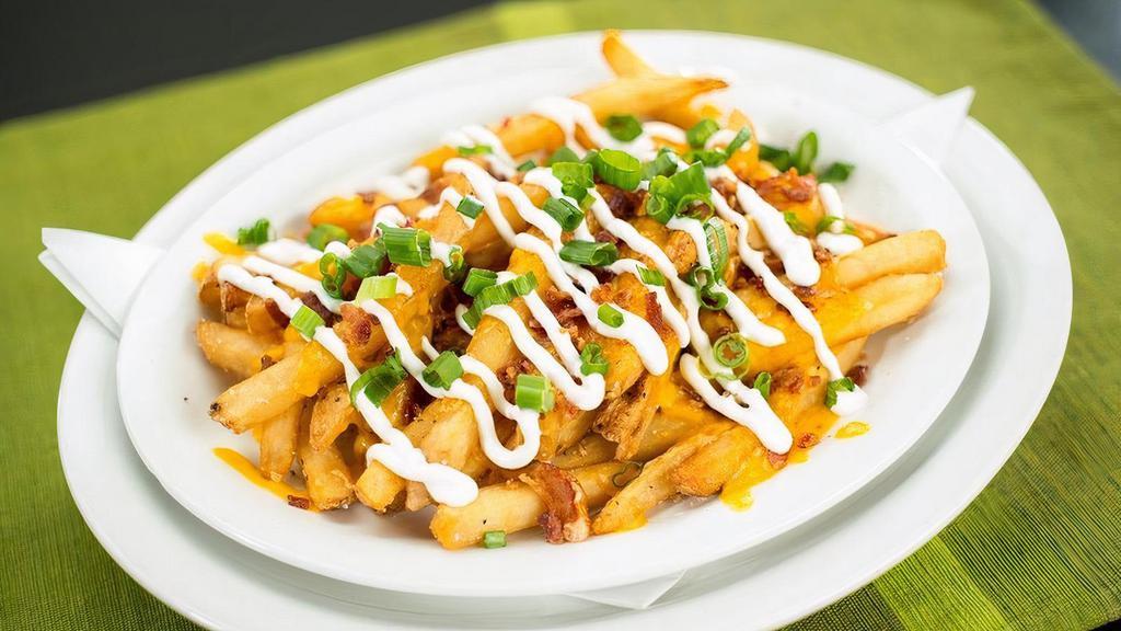 Loaded Fries · Large portion of our signature seasoned fries with cheddar jack cheese, bacon, sour cream, and scallions.