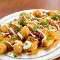 Loaded Tots · You gonna eat your tots? We serve ’em nice and crispy with cheddar jack cheese, bacon, sour ...