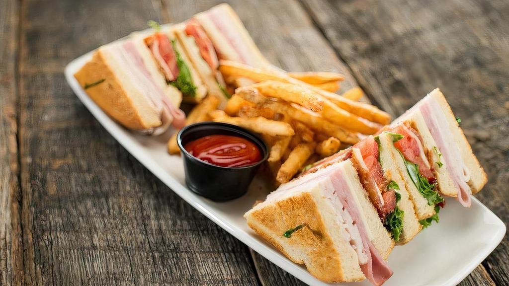 Club Sandwich · A traditional favorite with roasted turkey breast, smoked ham, hardwood smoked bacon, mozzarella cheese, lettuce, tomato, and mayonnaise.