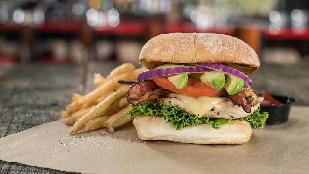 California Cluck · Charbroiled chicken breast on a toasted brioche bun topped with crisp bacon, sliced avocado, pepper jack cheese, lettuce, red onion, tomato, and mayonnaise.